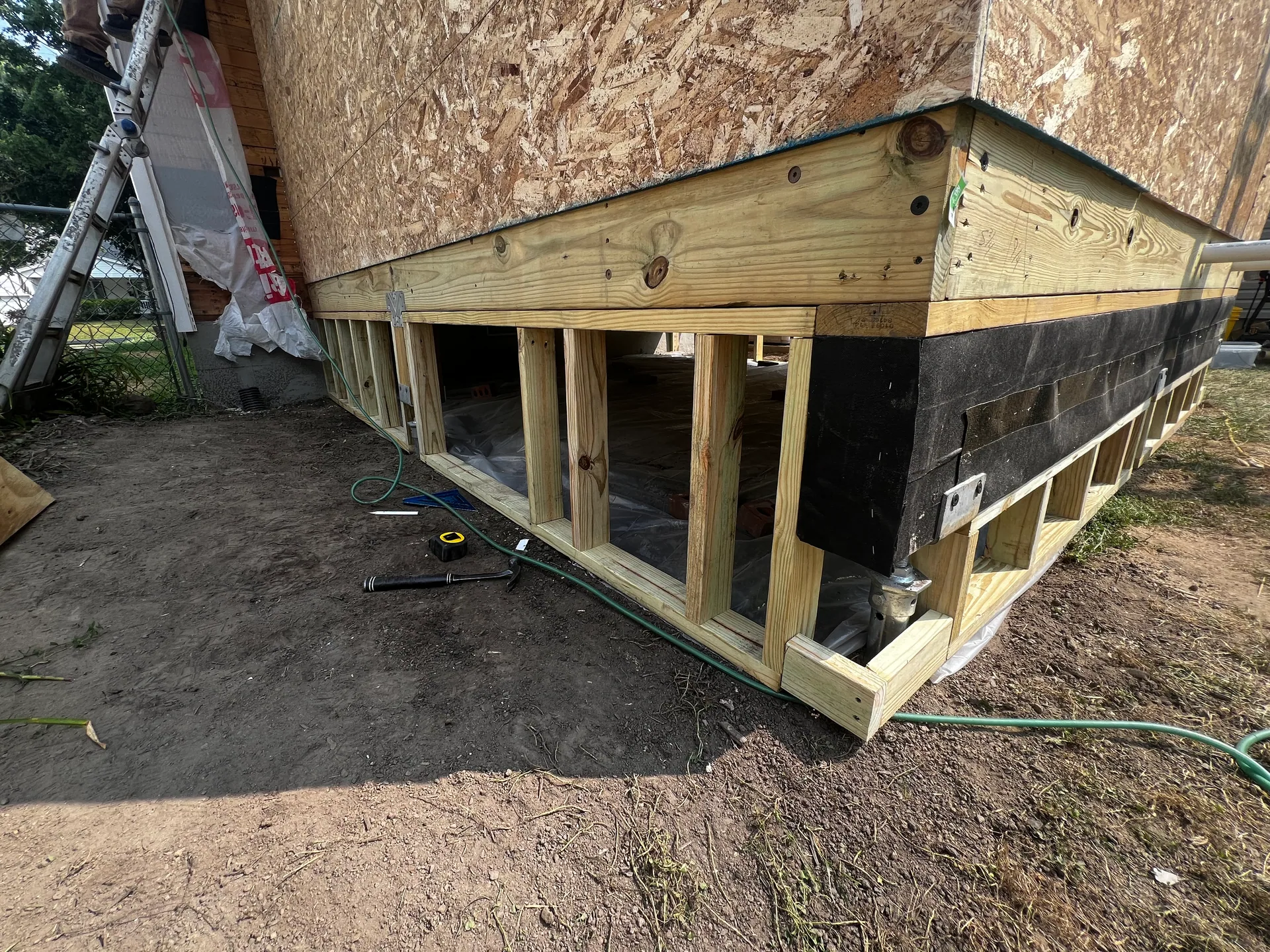 addition corner pressure treated rim joist open floor cavity garden hose amherst