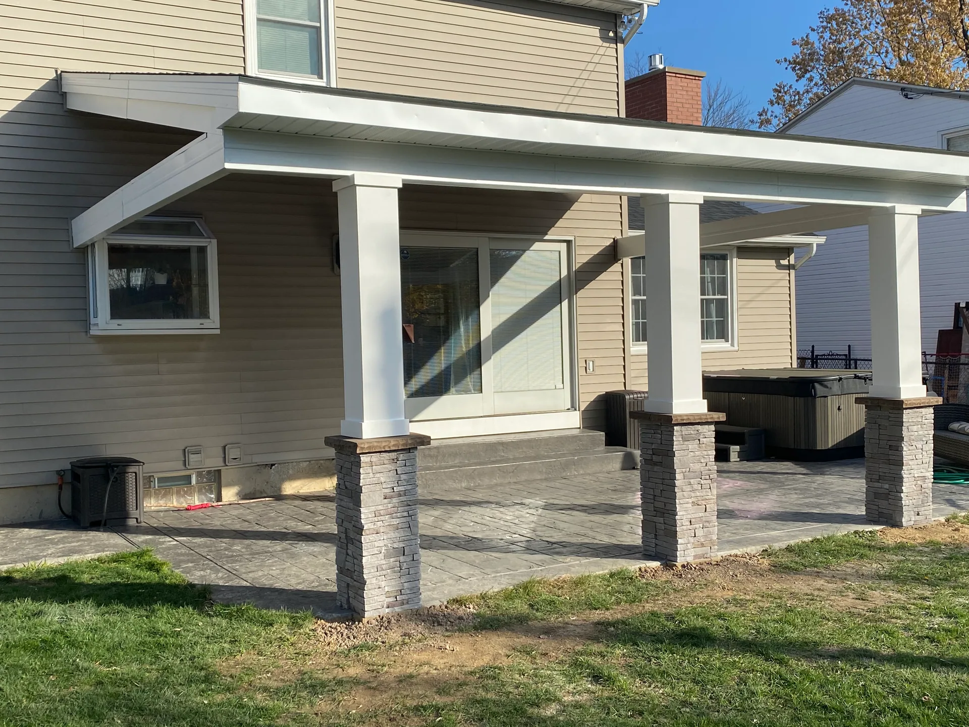 backyard patio cover white columns stone piers stamped concrete silver springs