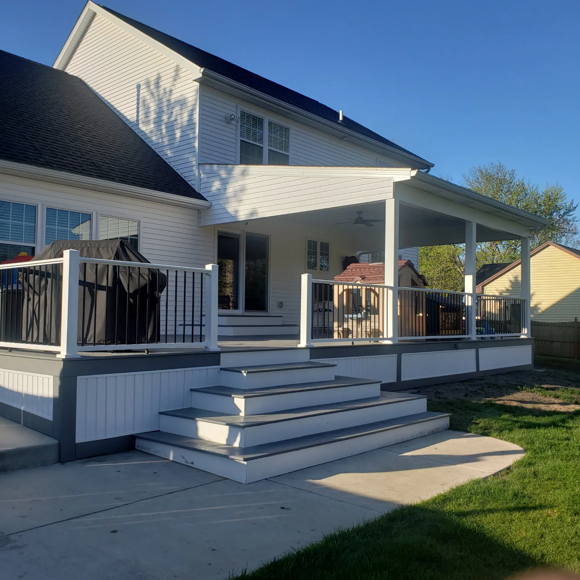 covered composite deck wide steps white railing ceiling fan silver springs ny