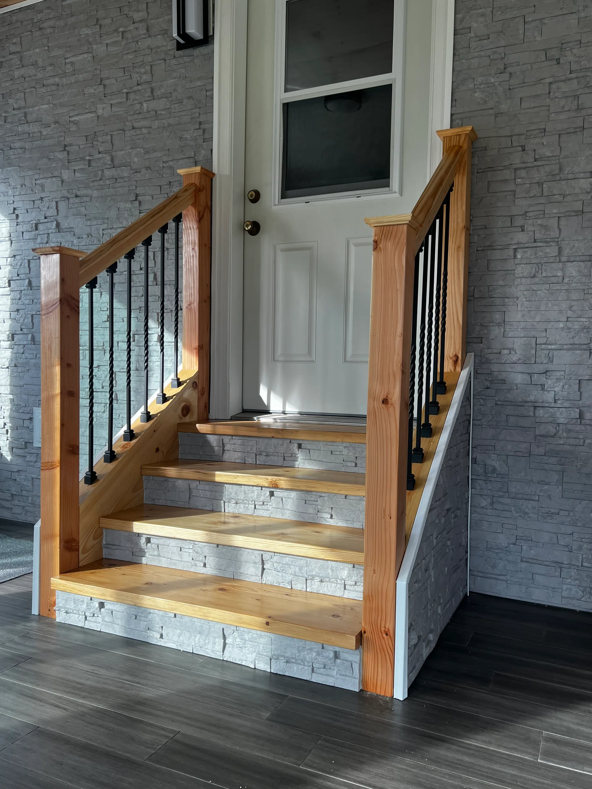 four step pine stairs white entry door stacked stone walls sunroom addition ny