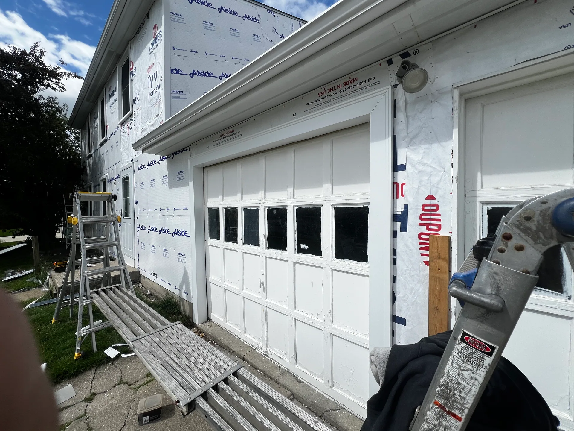 garage front wall tyvek wrap aluminum plank scaffold ladder siding prep western 